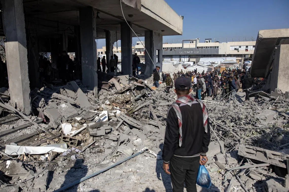 Palestinians inspect the site of an Israeli airstrike in Khan Yunis in the southern Gaza Strip, on Jan 2.