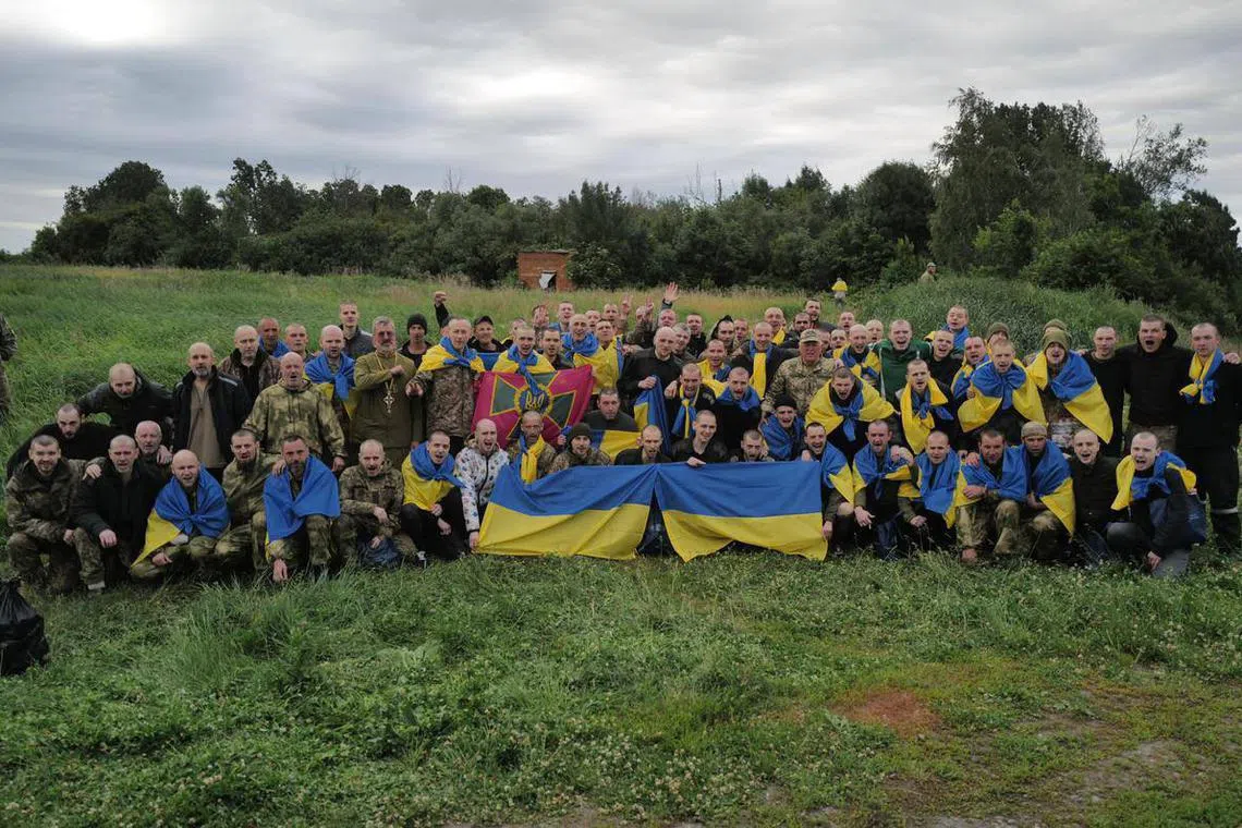 Ukrainian prisoners of war return home in June 2023.