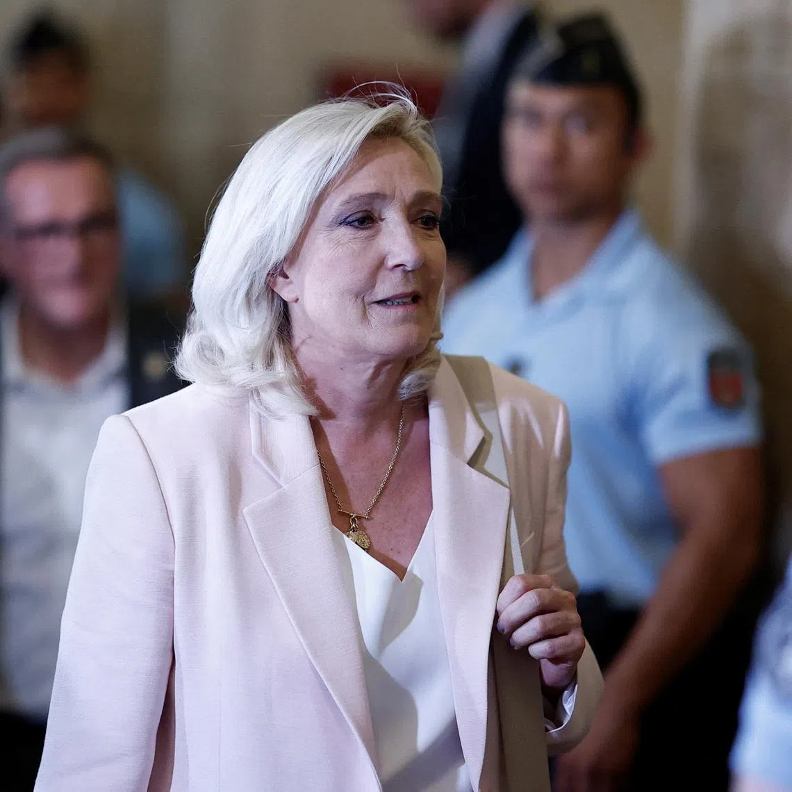 French far-right leader Marine Le Pen, member of parliament for the Rassemblement National (National Rally - RN) party, leaves after the verdict in her appeal trial, alongside the RN party itself and 10 others defendants found guilty of diverting European Parliament funds, at the Paris courthouse on the Ile de la Cite, in Paris, France, July 7, 2026. REUTERS/Benoit Tessier