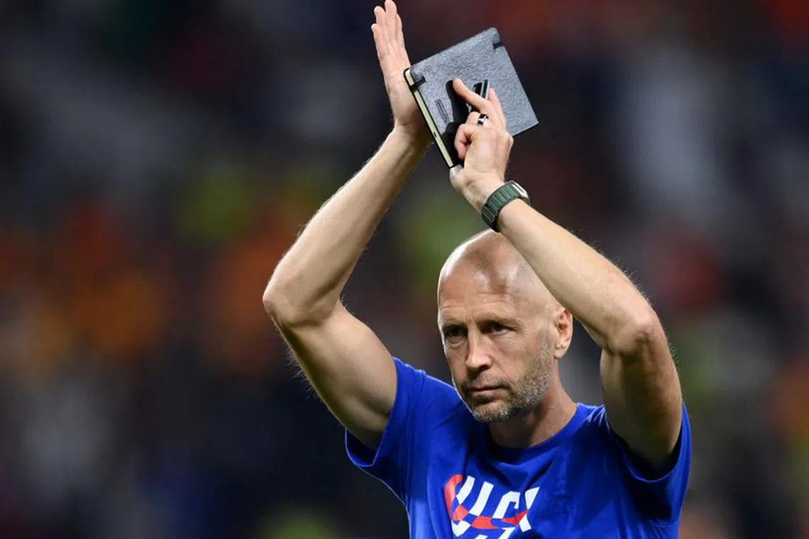 FILE PHOTO:Soccer Football - FIFA World Cup Qatar 2022 - Round of 16 - Netherlands v United States - Khalifa International Stadium, Doha, Qatar - December 3, 2022 U.S. coach Gregg Berhalter applauds fans after the match as United States are eliminated from the World Cup REUTERS/Annegret Hilse/File Photo