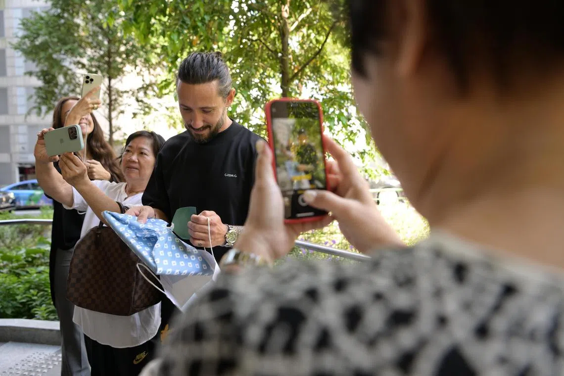 French pastry chef Cedric Grolet opening a present from a fan when he was in town for the patisserie's opening. 