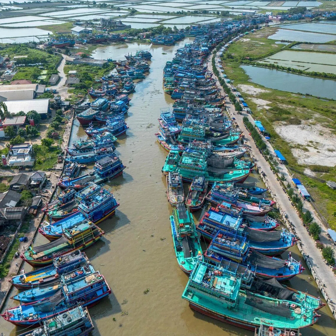 Fshing boats docked ashore at a port in Juwana, Central Java on May 6.