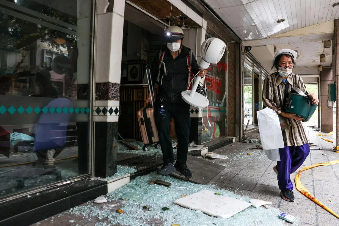 Residents salvage their belongings from the damaged Tongshuai building following the April 3 earthquake that hit Taiwan.