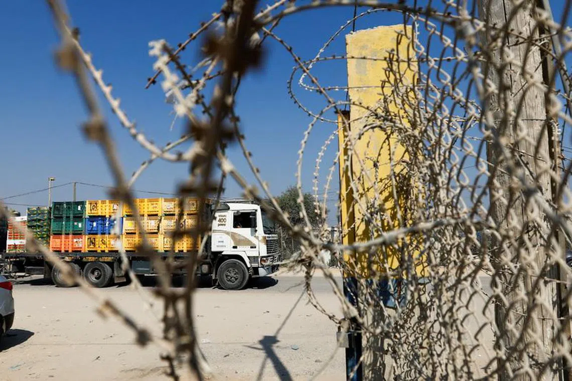 A view of Palestinian goods trucks in front of the commercial crossing of Kerem Shalom after the Israeli ban on Gaza exports deals a blow to the long-suffering economy, in Rafah in the southern Gaza Strip September 5, 2023. REUTERS/Ibraheem Abu Mustafa/File Photo