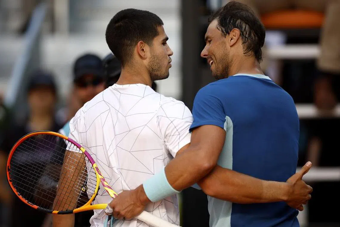 FILE PHOTO: Tennis - ATP Masters 1000 - Madrid Open - Caja Magica, Madrid, Spain - May 6, 2022 Spain's Carlos Alcaraz Garfia with Spain's Rafael Nadal after their quarter final match REUTERS/Juan Medina/File Photo