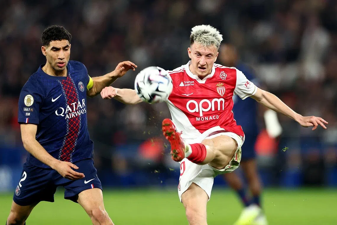 Soccer Football - Ligue 1 - Paris St Germain v AS Monaco - Parc des Princes, Paris, France - March 6, 2026 AS Monaco's Aleksandr Golovin in action with Paris St Germain's Achraf Hakimi REUTERS/Abdul Saboor
