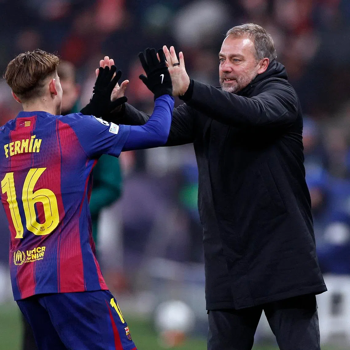 Soccer Football - UEFA Champions League - Slavia Prague v FC Barcelona - Fortuna Arena, Prague, Czech Republic - January 21, 2026 FC Barcelona's Fermin Lopez celebrates scoring their second goal with FC Barcelona coach Hansi Flick REUTERS/David W Cerny