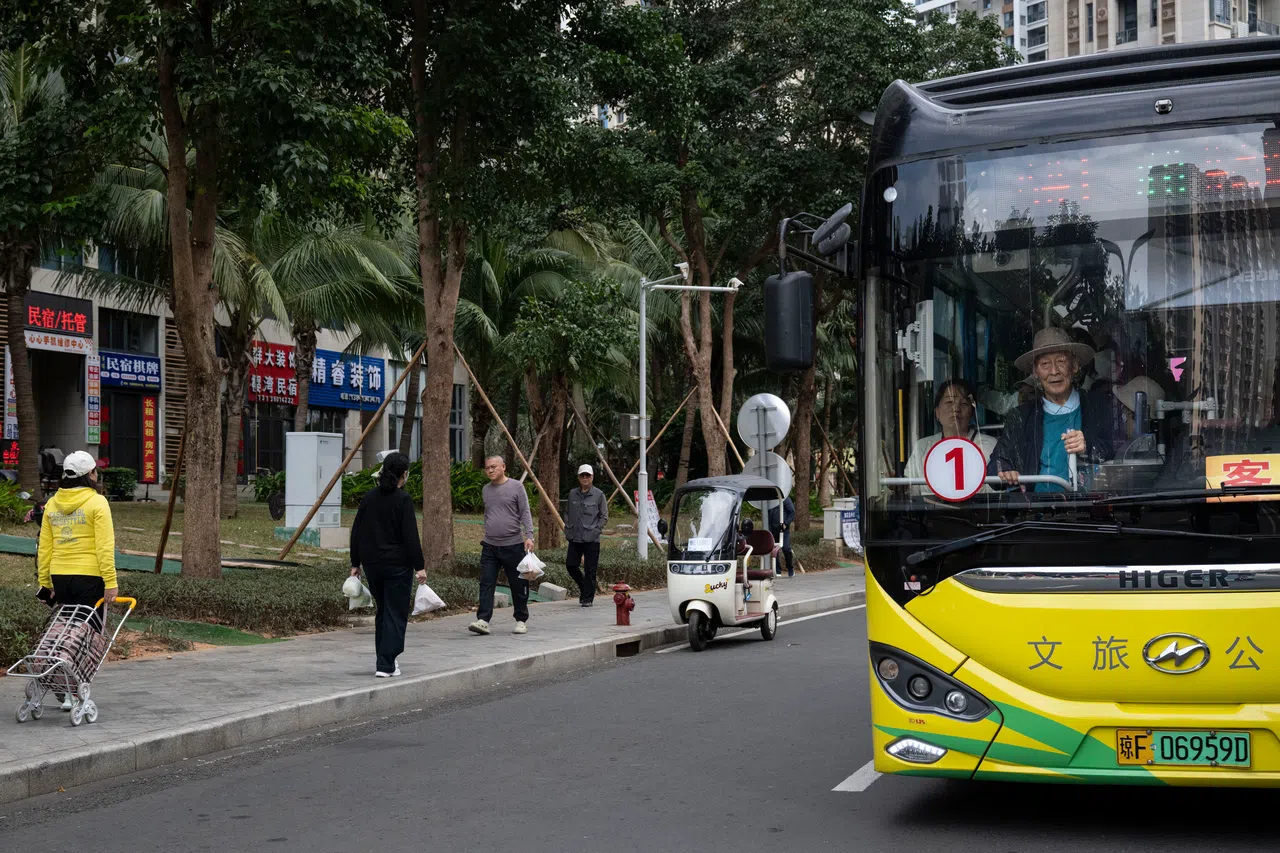 A bus and pedestrians on the man-made development of Ocean Flower Island, in the South China Sea just off Hainan, on Jan 2.