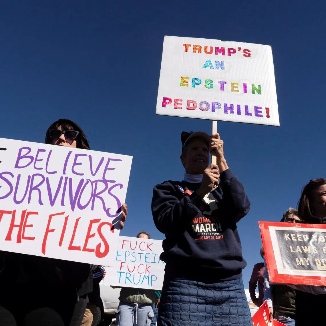 Protesters hold signs outside Zorro Ranch, a property formerly owned by Jeffrey Epstein, on International Women’s Day near Stanley, New Mexico, U.S. March 8, 2026.  REUTERS/Rebecca Noble
