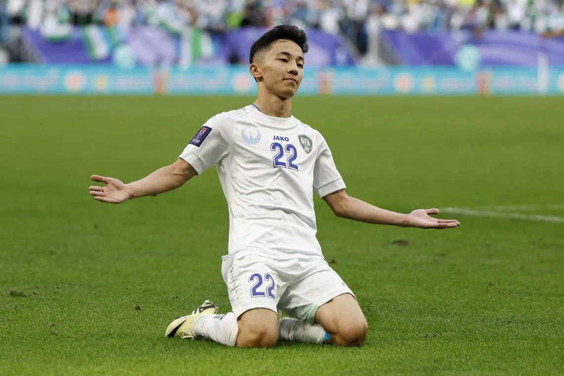 Uzbekistan's Abbosbek Fayzullayev celebrates scoring their second goal against Thailand.