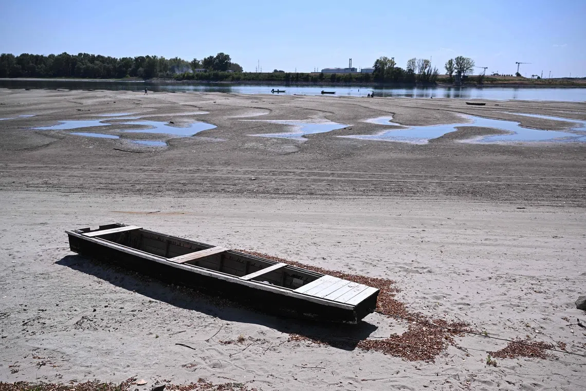 A view of the dried-up Danube riverbed with the Paks power plant in the background, near Dunaszentbenedek, close to Paks town, on July 31.