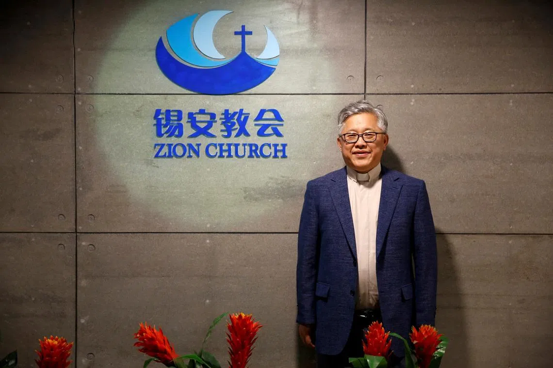 FILE PHOTO: The head pastor of the Zion church in Beijing Jin Mingri poses for picures in the lobby of the unofficial Protestant \"house\" church in Beijing, China, August 28, 2018.  Picture taken August 28, 2018.  REUTERS/Thomas Peter/File Photo