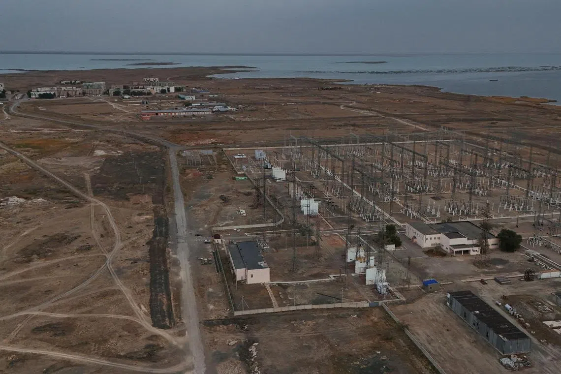 A drone view shows an electrical substation and the village of Ulken on the eve of the referendum on the construction of a nuclear power plant, in the Almaty Region, Kazakhstan October 5, 2024. The village of Ulken was selected as the most preferred location for the construction of a nuclear power plant. REUTERS/Pavel Mikheyev