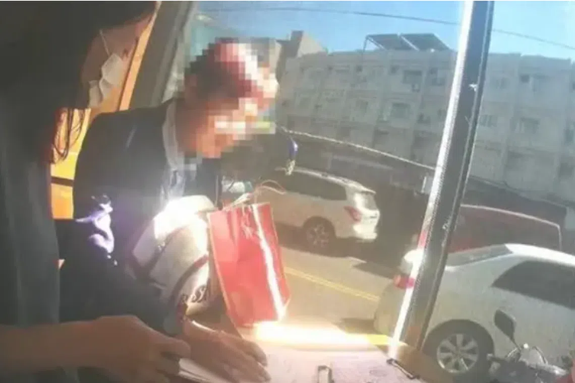 Ady Hu (second from left) in a Taiwanese police sting photo shortly before being detained on alleged fraud.