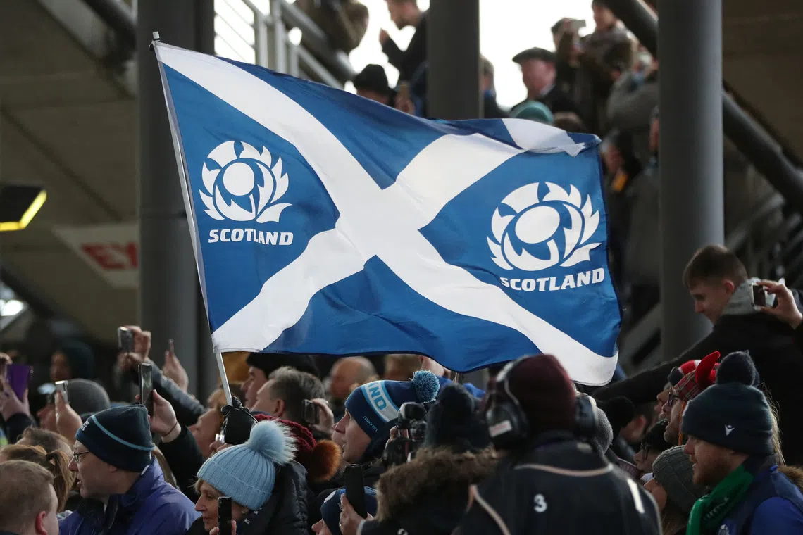 Scotland rugby fans wave a flag before a Six Nations Championship match at Murrayfield Stadium in Edinburgh.