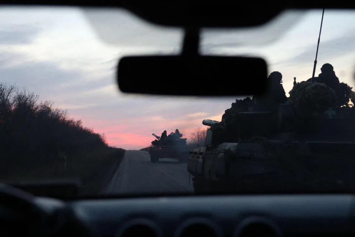 Ukrainian tanks ride on a road outside Avdiivka, in Ukraine's Donetsk region, amid Russia's invasion.