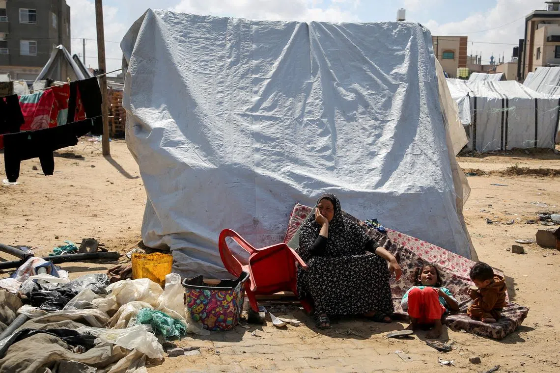 Displaced Palestinians waiting to evacuate a tent camp after Israeli forces launched an operation in the eastern part of Rafah, in the southern Gaza Strip, on May 7.