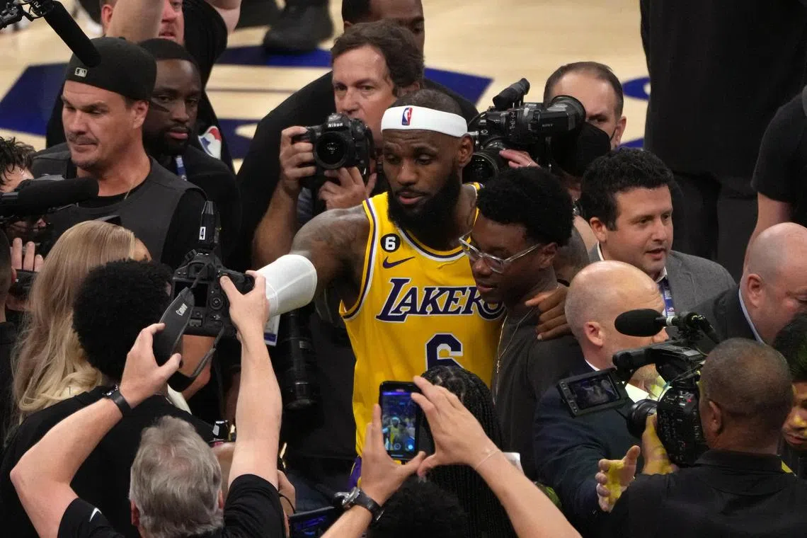 LeBron James hugs his son after becoming the all-time highest scoring player in NBA history.