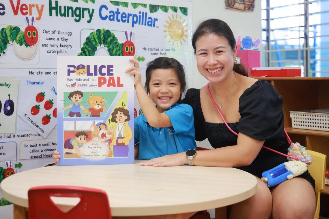Juel Lee and her mother Chua Mei Ling, pictured with the SGSecure edition of the Police Pal storybook series for preschoolers at MOE Kindergarten at West Spring on Oct 5.
