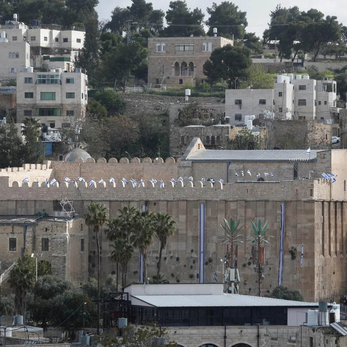 Israeli flags flutter on the Ibrahimi mosque, also known as the Cave of the Patriarchs, in Hebron, in the Israeli-occupied West Bank. 