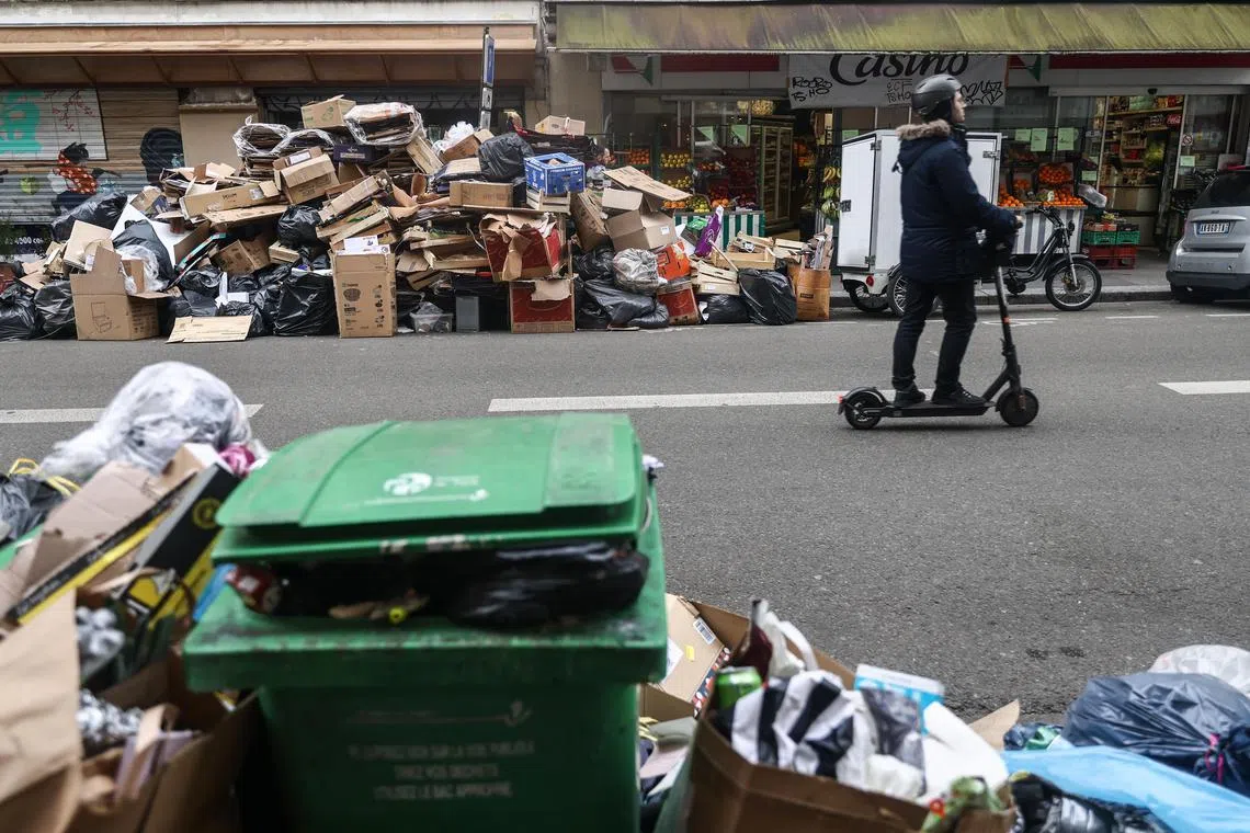 Garbage cans overflowing with trash in Paris last Friday.