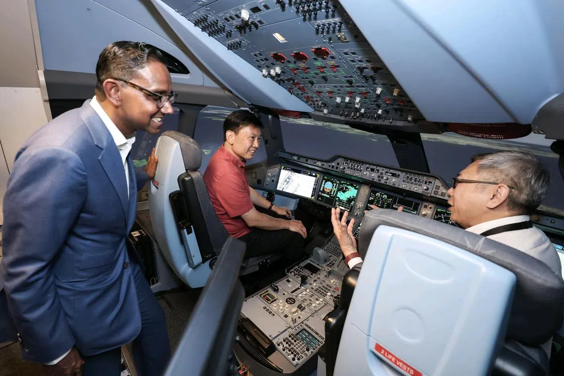 Transport Minister Chee Hong Tat viewing an A350 simulation training pod at the Airbus Asia Training Centre, during his tour of the Airbus Singapore Campus in Seletar Aerospace Park on May 7. 