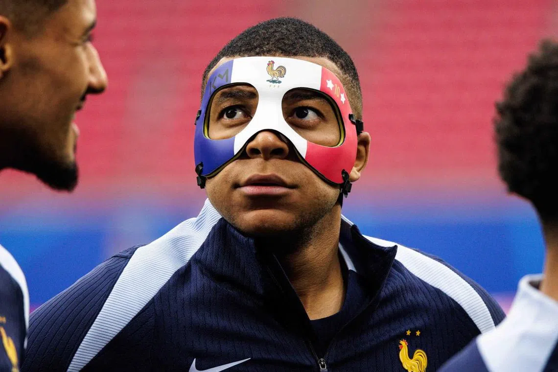 France's Kylian Mbappe wearing a protective mask during a training session on June 20.