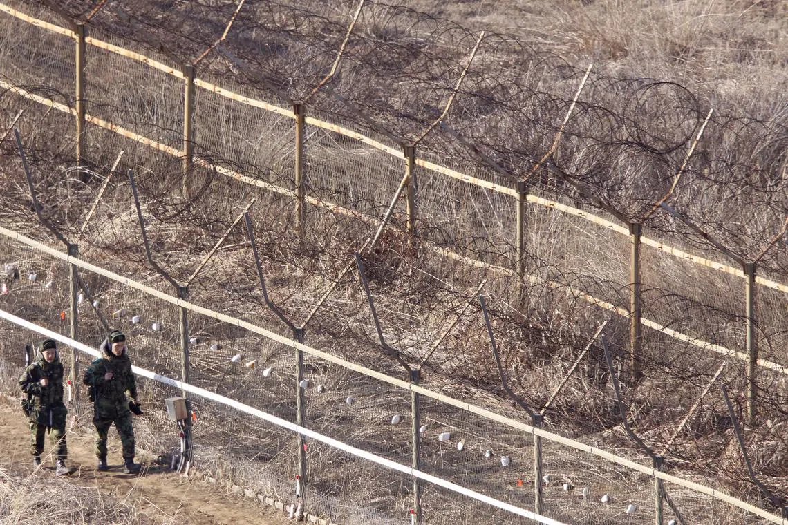 FILE PHOTO: South Korean soldiers patrol near the demilitarized zone separating the two Koreas in Goseong, about 330 km (205 miles) northeast of Seoul, February 16, 2009. REUTERS/Lee Jae-Won/File Photo