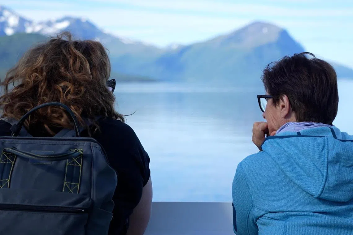 Tourists looking at the landscape aboard the ferry in Margerholm, Norway, on June 27.