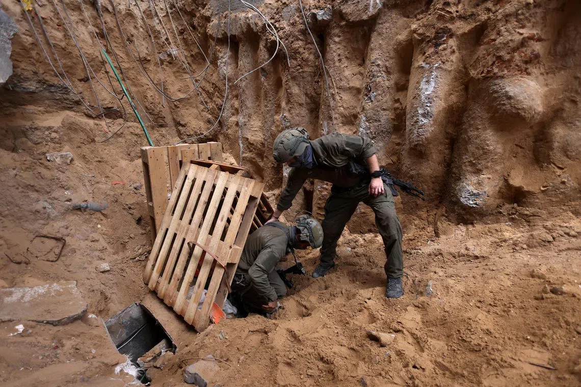 Israeli soldiers at the opening to a tunnel, at the Al Shifa Hospital compound in Gaza City, in November 2023.