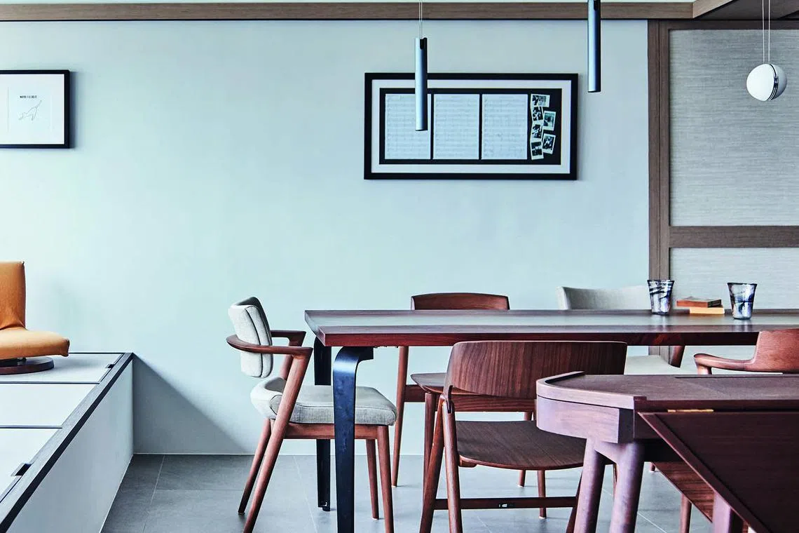 The dining area enjoys plenty of natural light from the windows and balcony.