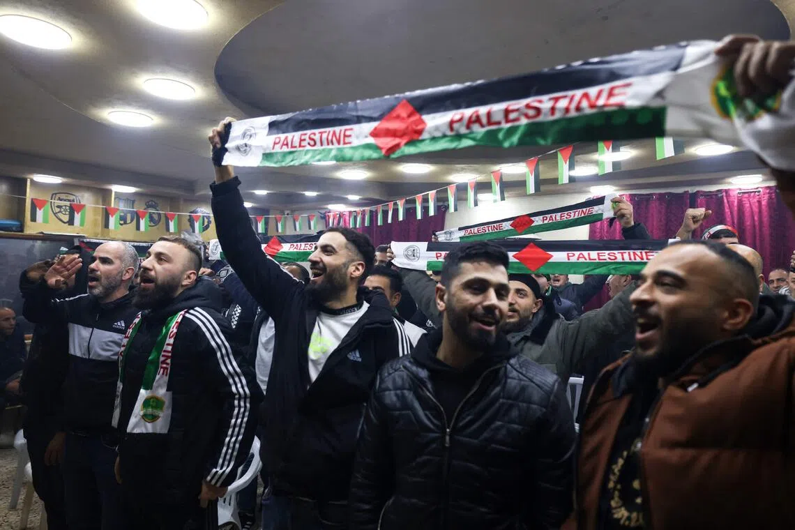 Palestinians in the occupied West Bank cheer as they watch their team play Saudi Arabia during the Fifa Arab Cup.
