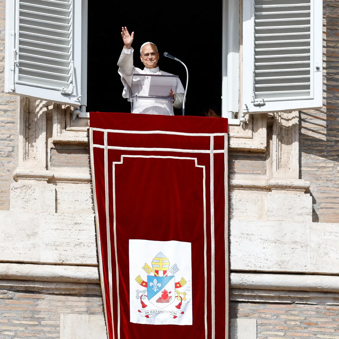 Pope Leo waved and smiled to the crowds after reaching the window unaided.