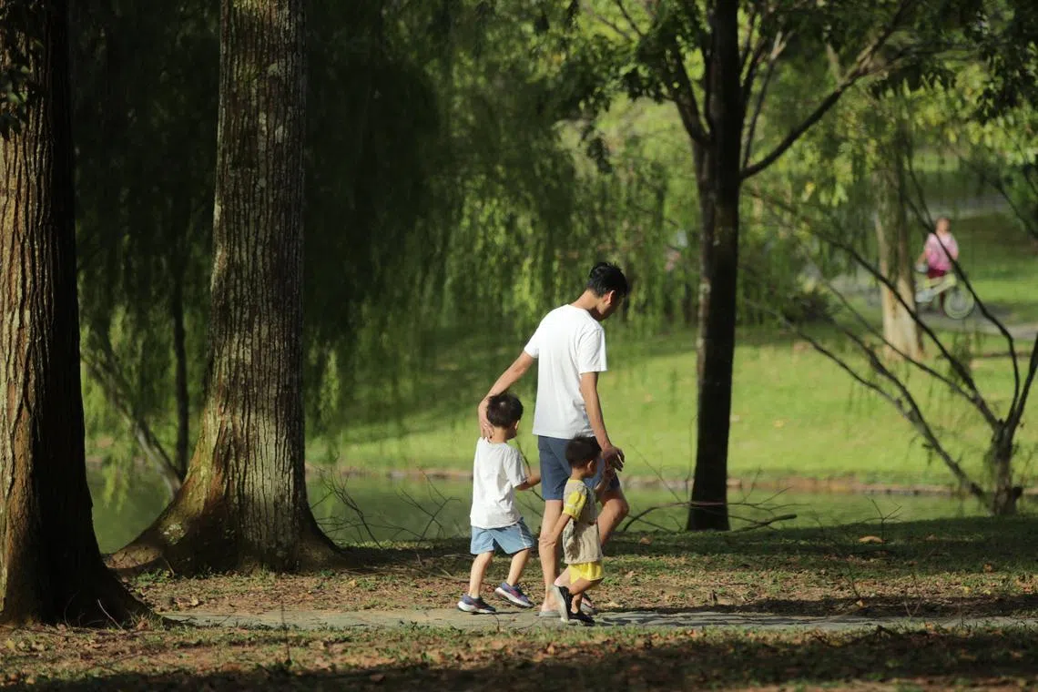 Father with his two children strolling at Bishan Park-Ang Mo Kio Park, 26 February 2023.  park, greenery, family, parenthood, single father, family bonding, fatherhood