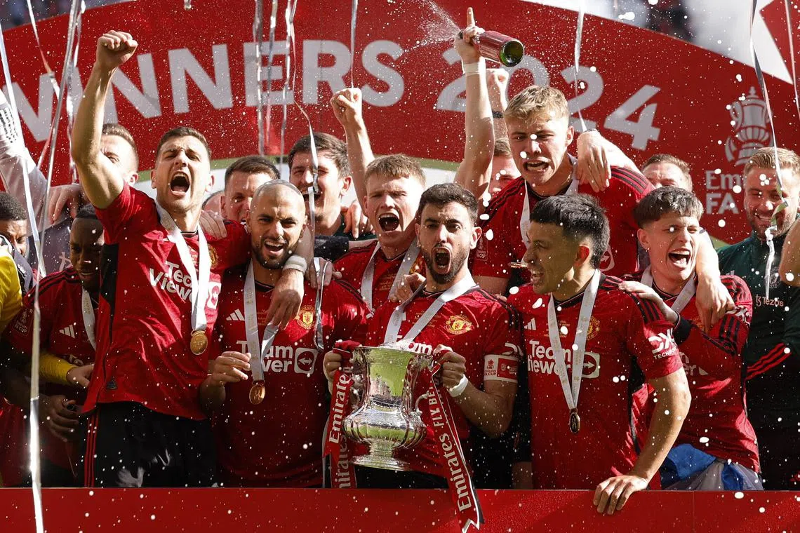Soccer Football - FA Cup - Final - Manchester City v Manchester United - Wembley Stadium, London, Britain - May 25, 2024
Manchester United's Bruno Fernandes celebrates with the trophy and teammates after winning the FA Cup Action Images via Reuters/Andrew Couldridge