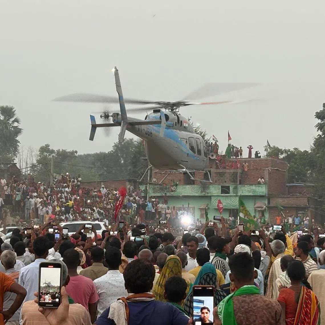 A crowd watching as opposition leader Tejashwi Yadav of the Rashtriya Janata Dal leaves a Bihar rally in a helicopter on Nov 3. 