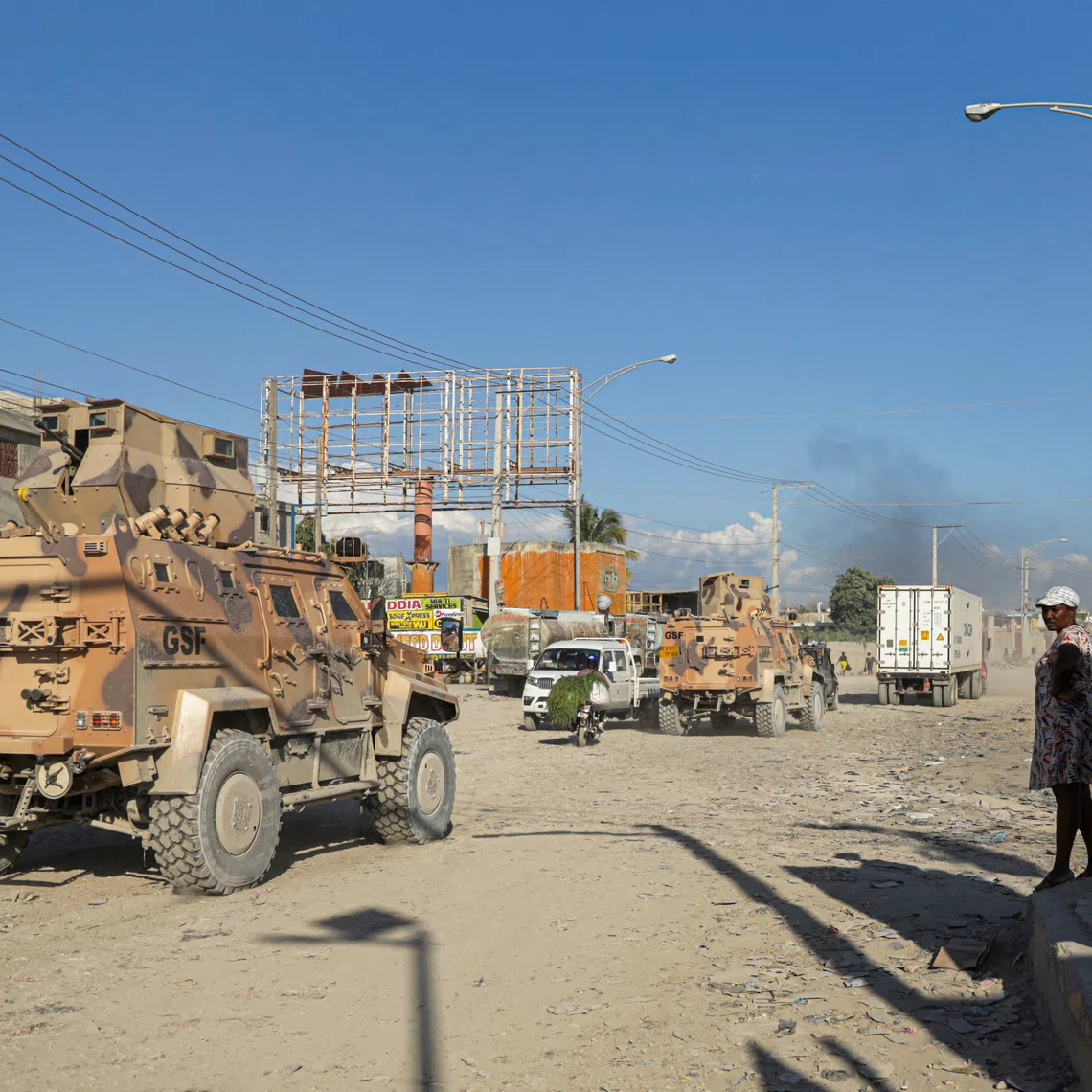 Armored personnel carriers of Haiti's UN-backed Gang Suppression Force (GSF) patrol an area after heavily armed gangs ambushed members of the force, attacking their armored vehicle with explosives, setting it ablaze and leaving four Salvadoran troops missing when they fled their burning vehicle, in Port-au-Prince, Haiti, October 19, 2026. REUTERS/Patrice Noel