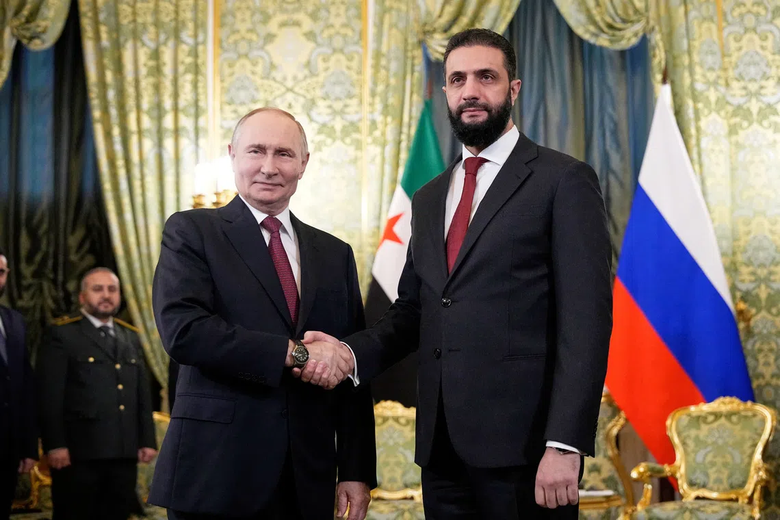 Russia's President Vladimir Putin shakes hands with Syria's President Ahmed al-Sharaa during a meeting at the Kremlin in Moscow, Russia, October 15, 2025. Alexander Zemlianichenko/Pool via REUTERS
