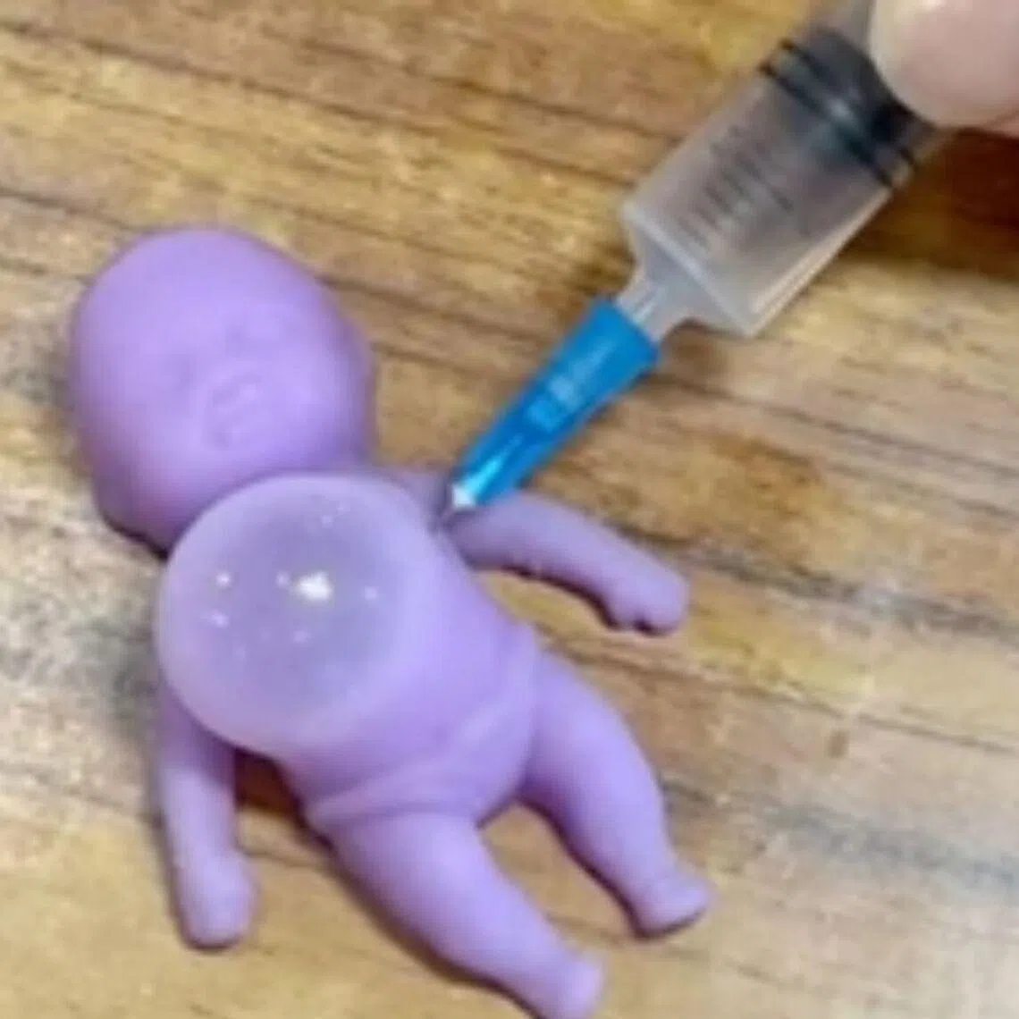 The product is marketed as a stress-relieving item, where a syringe is used to inject air into a squishy toy which then create a blister-like bulge that can be squeezed or popped. 