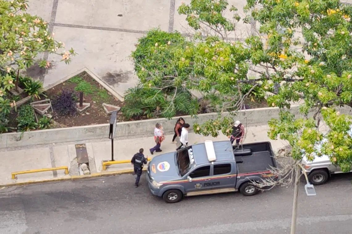 Venezuelan journalist Carmela Longo walks towards a police vehicle as she gets detained by police who raided her house, according to a journalists union and a local rights organisation, in Caracas, Venezuela, August 25, 2024 in this screengrab taken from a social media video. Jesus Medina Ezaine/via REUTERS
