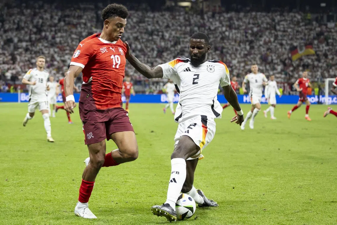 Germany's Antonio Ruediger shielding the ball from Switzerland's Dan Ndoye in their Euro 2024 Group A match in Frankfurt on June 23, 2024.