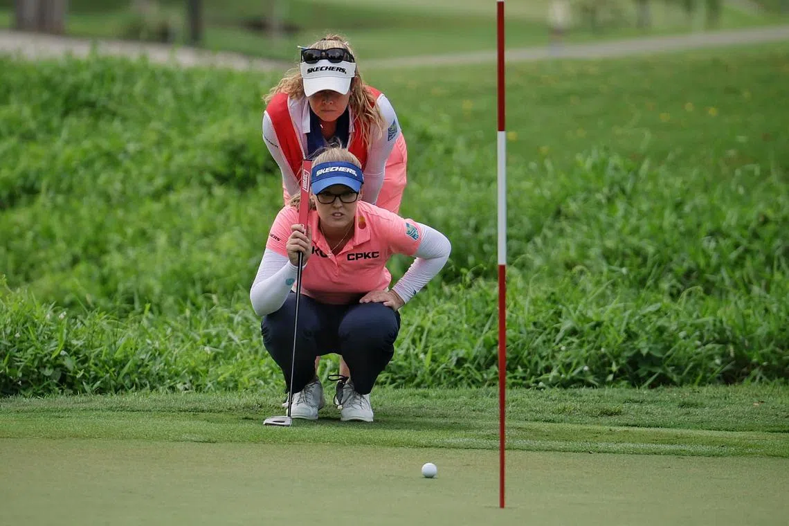 Brooke Henderson of Canada reading the green with her sister and caddie Brittany during the third round of the HSBC Women's World Championship.