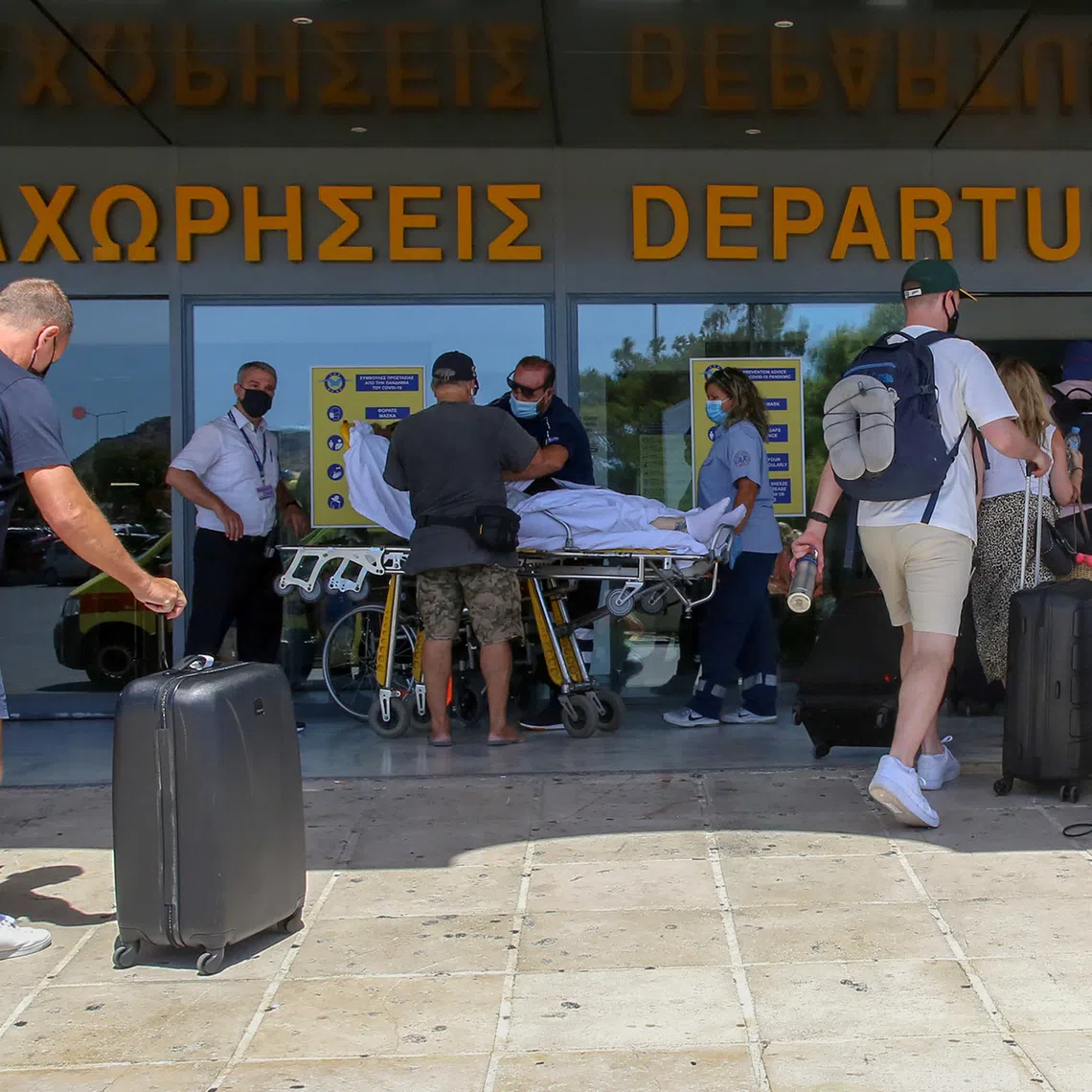 Tourists enter the departures lounge of the airport of Heraklion, on the island of Crete, Greece, September 8, 2020. REUTERS/Stefanos Rapanis/File Photo