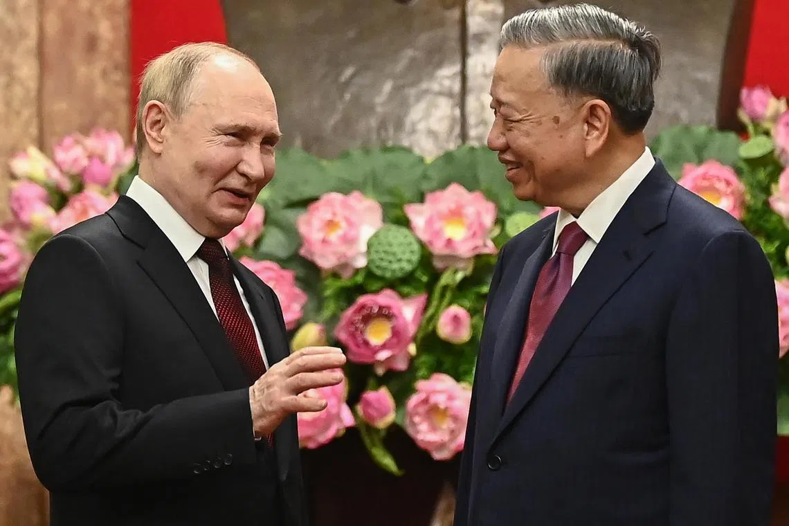 epa11424325 Vietnamese President To Lam (R) and his Russian counterpart Vladimir Putin (L) speak during an official visit at the Presidential Palace in Hanoi, Vietnam, 20 June 2024. Putin is on an official visit to Vietnam following his visit to North Korea.  EPA-EFE/NHAC NGUYEN / POOL