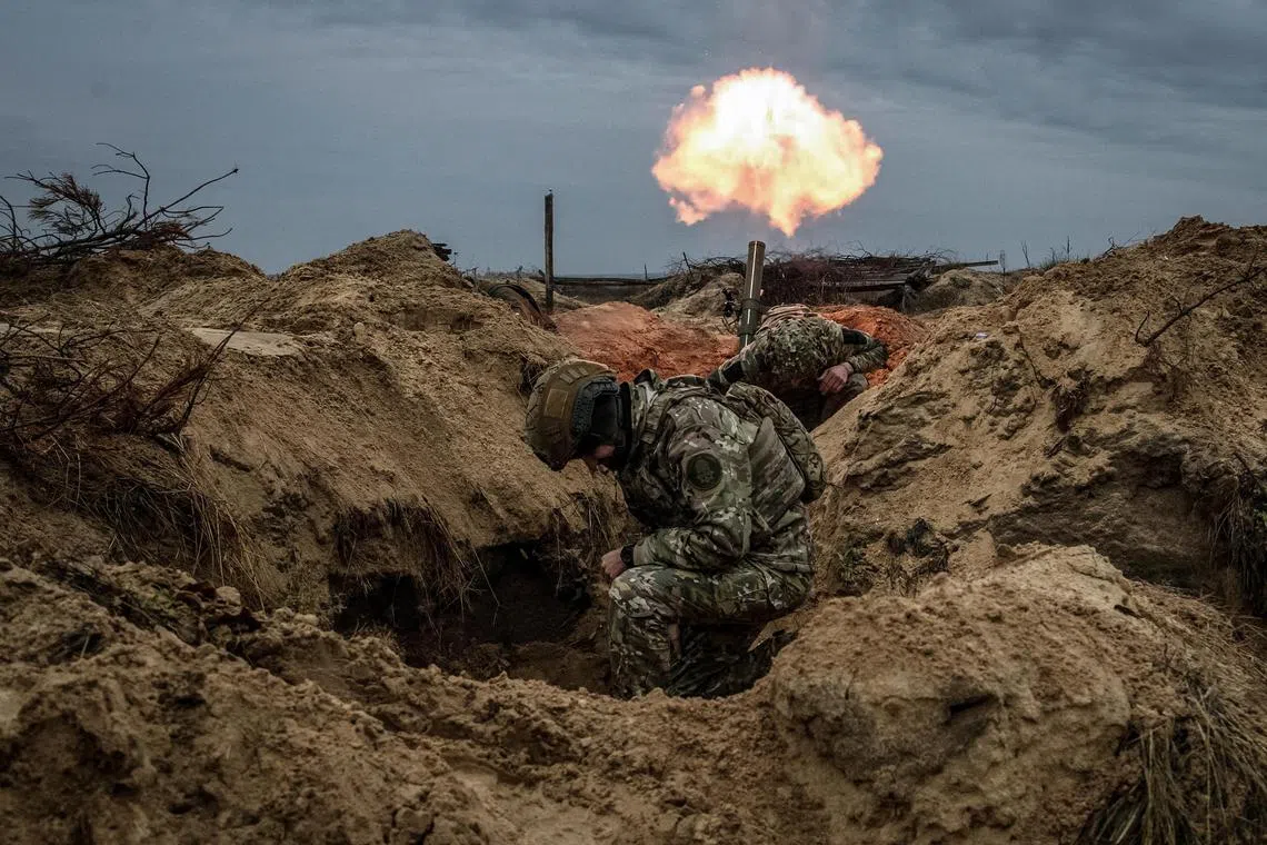 Ukrainian service men fire a mortar during an exercise in the Kyiv region, amid Russia's attack on Ukraine.