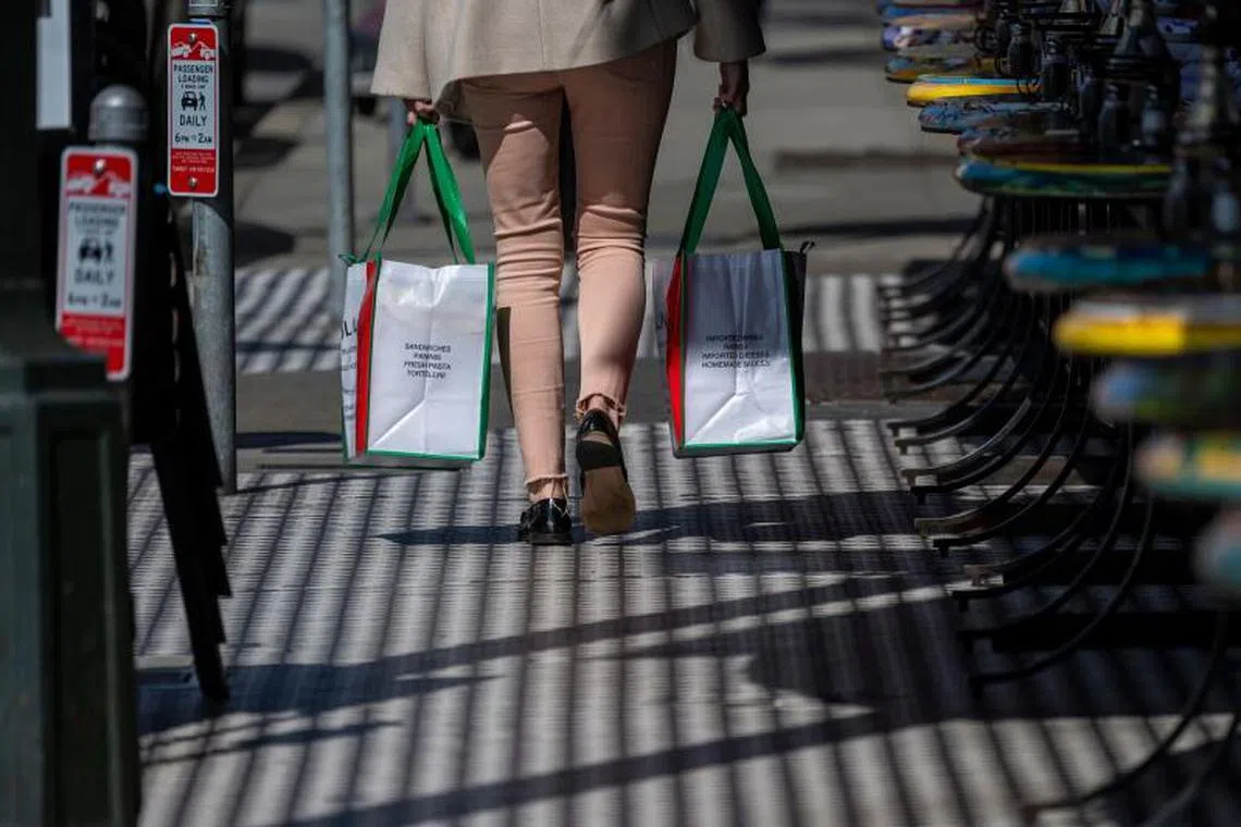 A shopper carries shopping bags in the North Beach neighborhood in San Francisco, California, US, on Tuesday, March 11, 2025. The Bureau of Labor Statistics is scheduled to release US consumer price index (CPI) figures on March 12. Photographer: David Paul Morris/Bloomberg