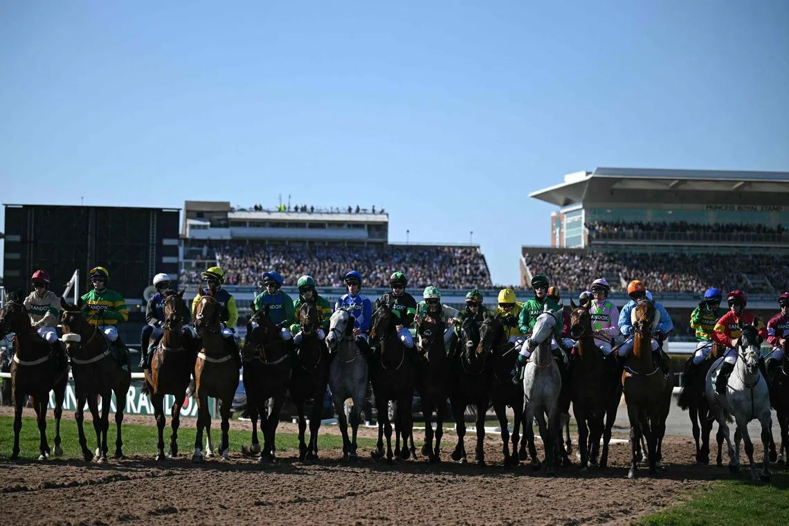 Horses and riders prepare to start the Grand National Handicap Chase on the final day of the Grand National Festival horse race meeting at Aintree Racecourse in Liverpool on April 5, 2025.