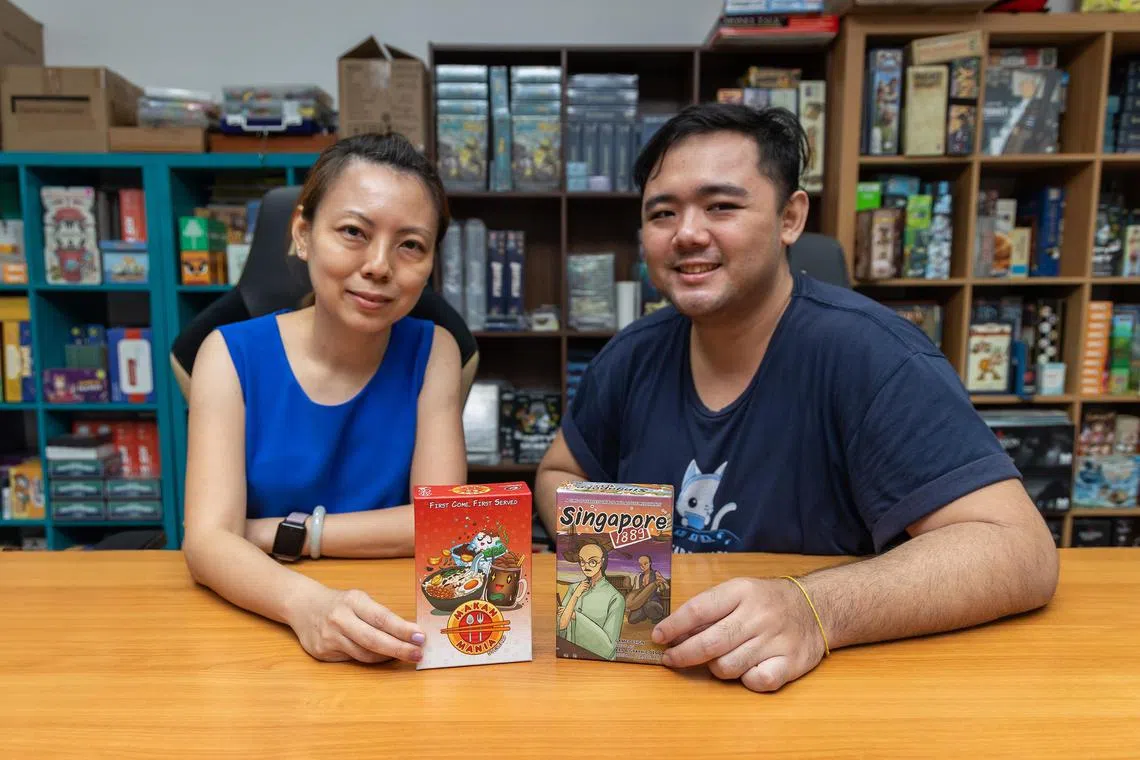 Co-founder of Capital Gains Studio Jaslyn Lim and game designer Steve Ng with their latest games - Makan Mania and Singapore 1889.