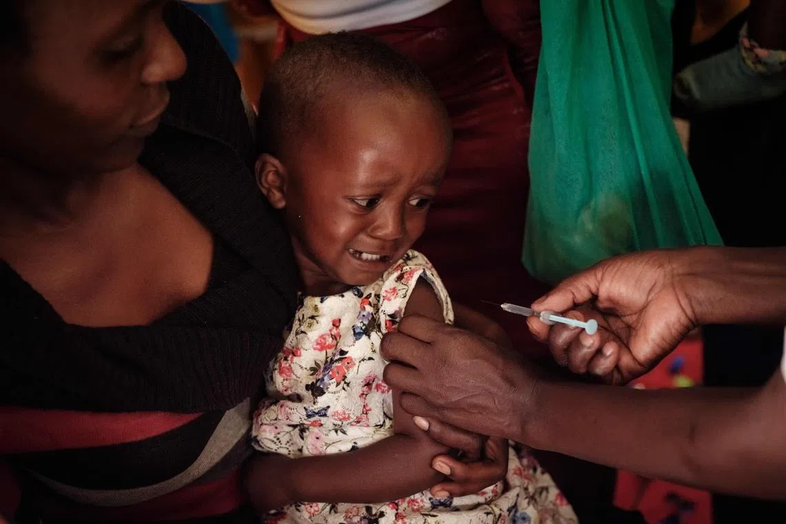 A child receives a shot during the launch of the extension of the world’s first malaria vaccine (RTS, S) pilot programme for children at risk of malaria illness and death.