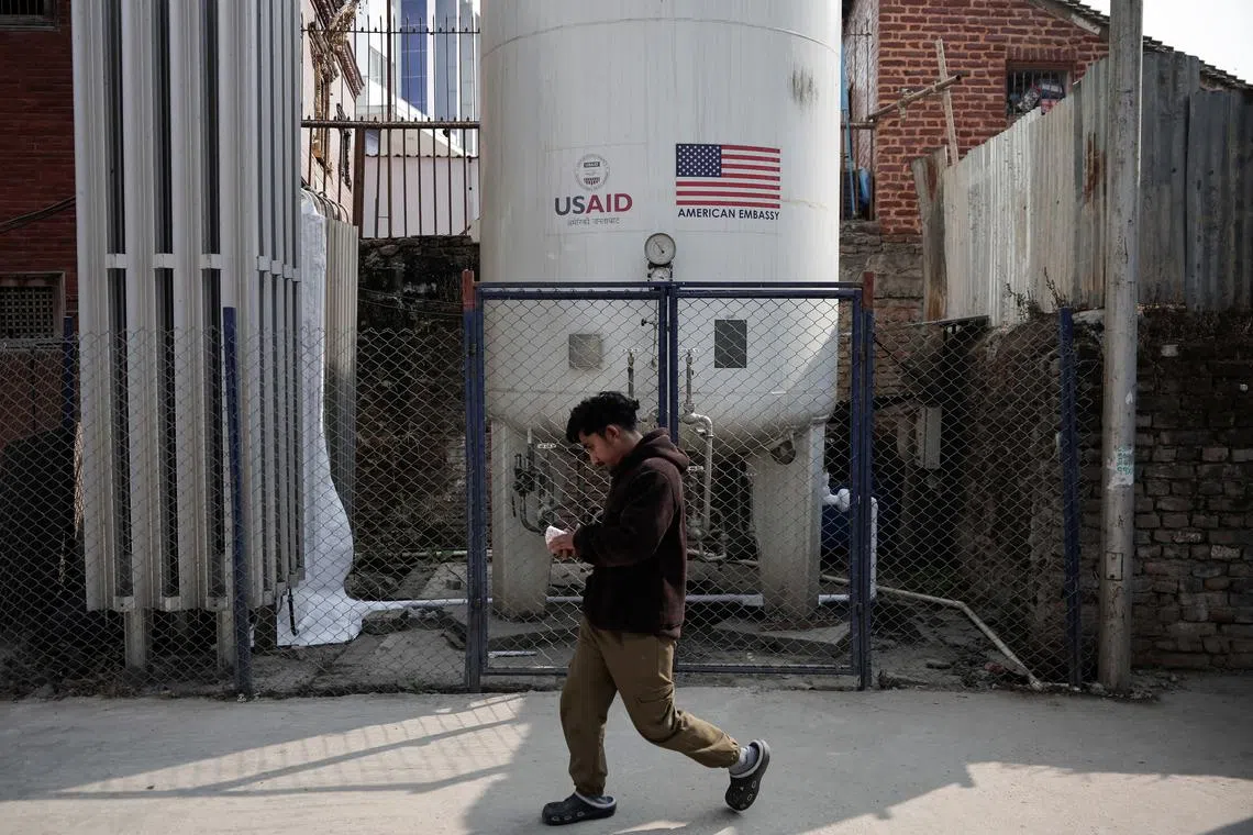 FILE PHOTO: A man walks past the liquid oxygen storage tank installed at Bir Hospital by the United States Agency for International Development (USAID), in Kathmandu, Nepal February 9, 2025. REUTERS/Navesh Chitrakar/File Photo